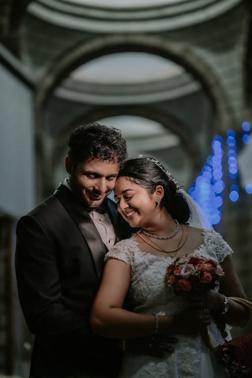 Portrait of Smiling and Hugging Newlyweds