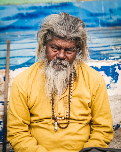 Portrait of a Senior Man with Gray Beard Wearing a Yellow Shirt