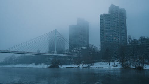 A bridge over a river in the fog