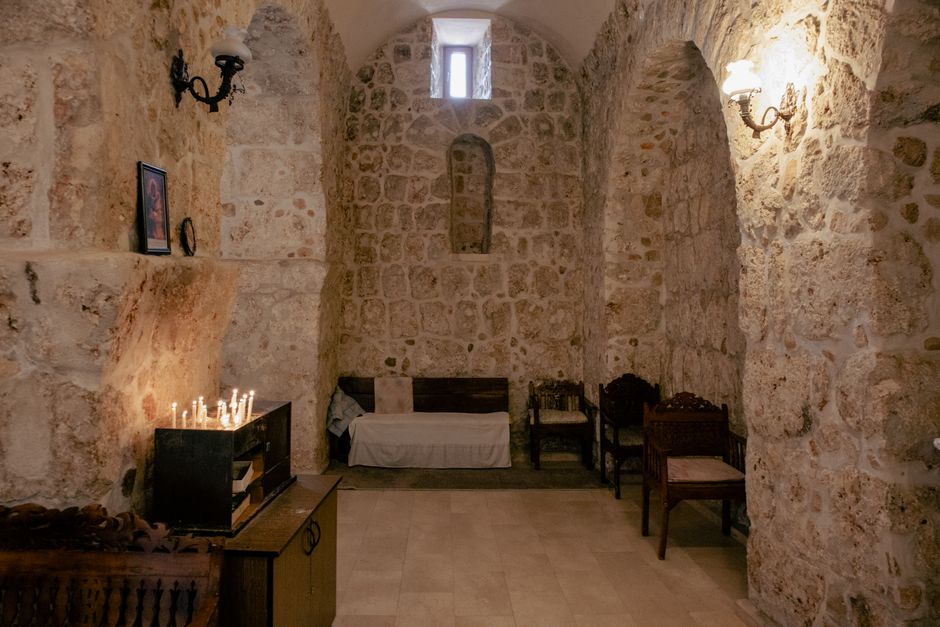 Women respectfully covering heads with scarves inside an ancient Armenian monastery