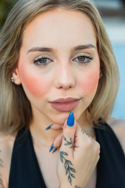 A woman with tattoos and blue lips