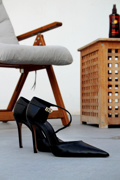 Close-Up photo of a Pair of Black High Heel Shoes on the Floor