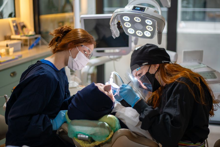 Dental team performing a routine checkup with modern equipment