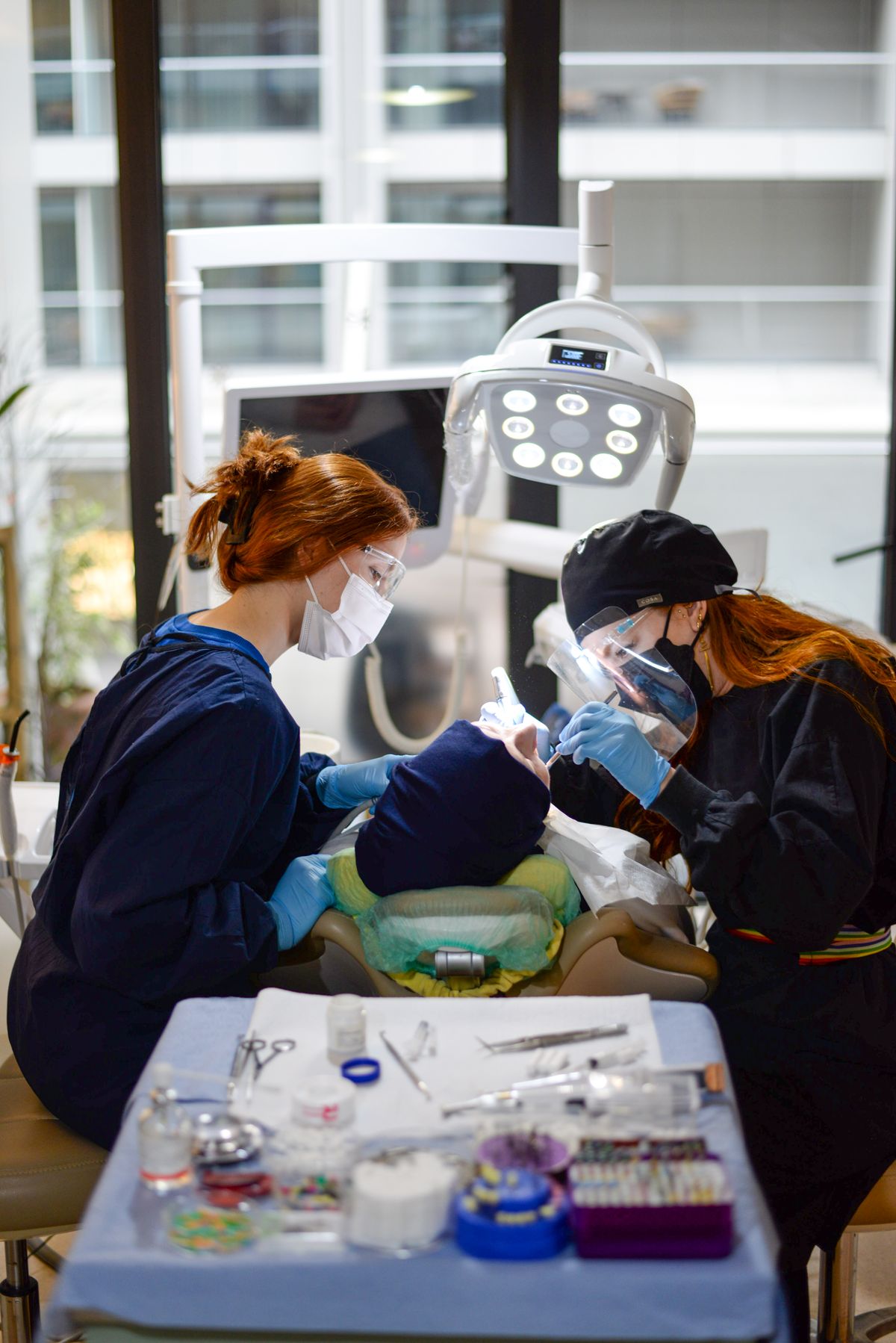 Dental team caring for a patient in a modern clinic
