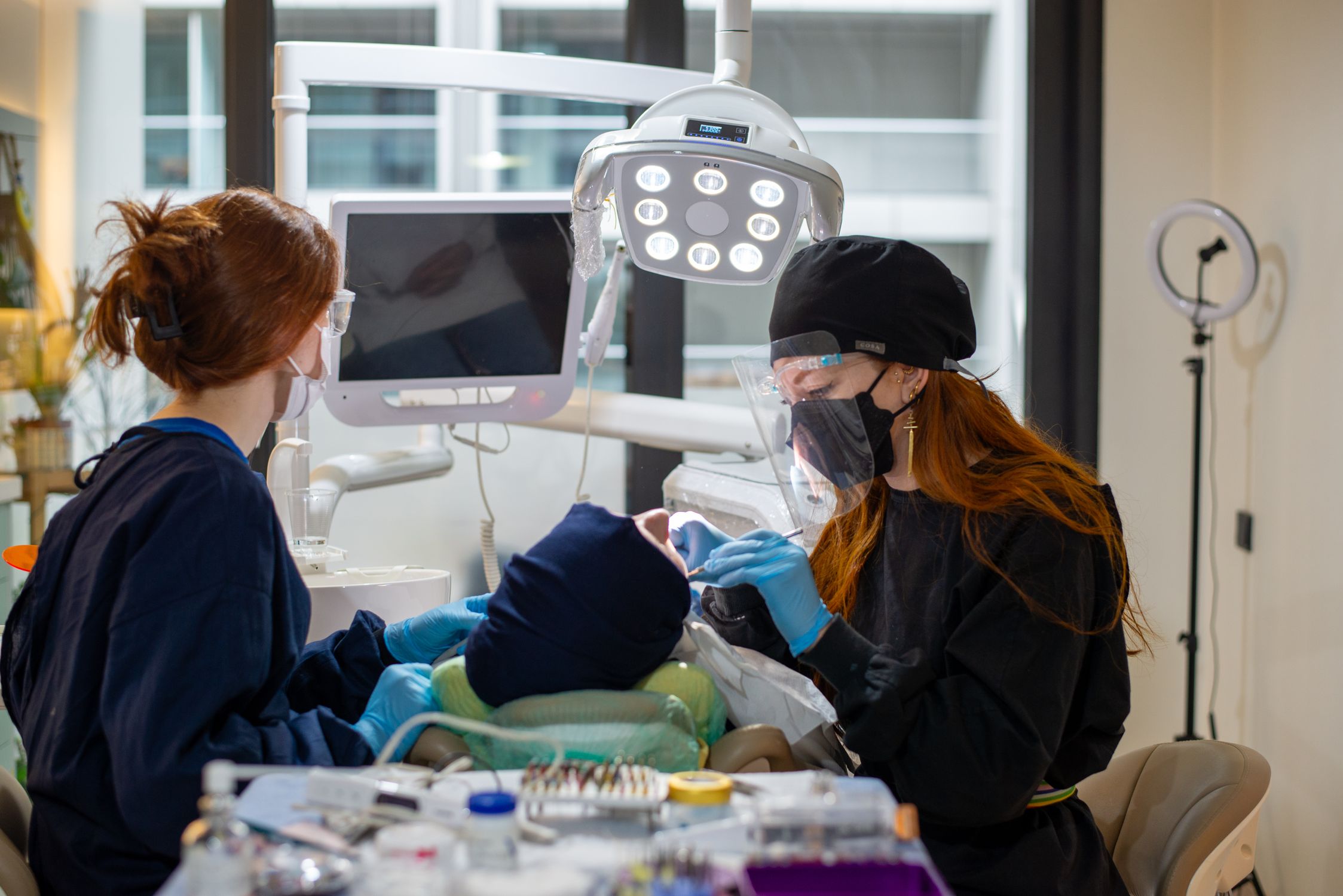 Dentists examining a patient during a consultation at a modern dental clinic