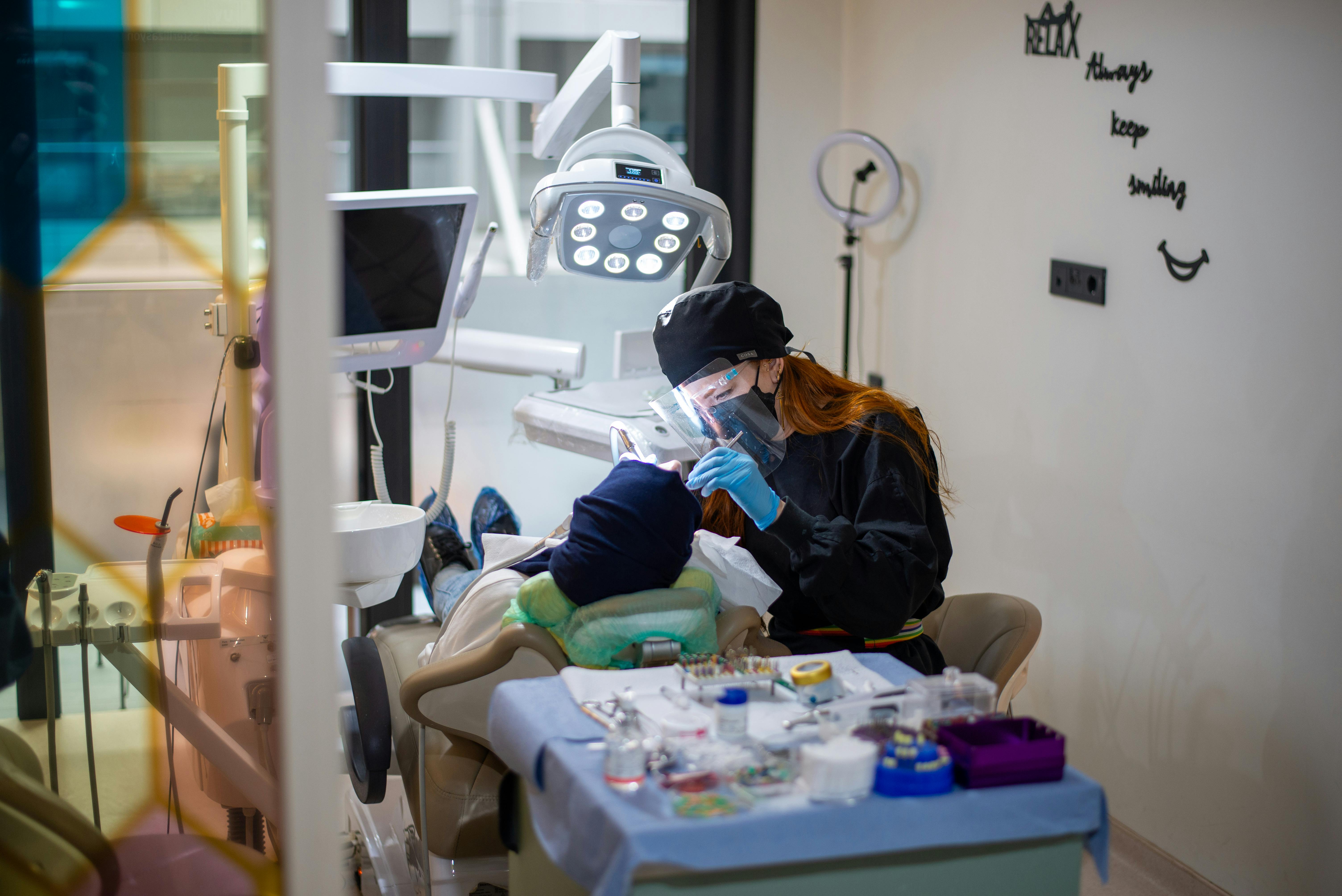 The dentist treats teeth of patient