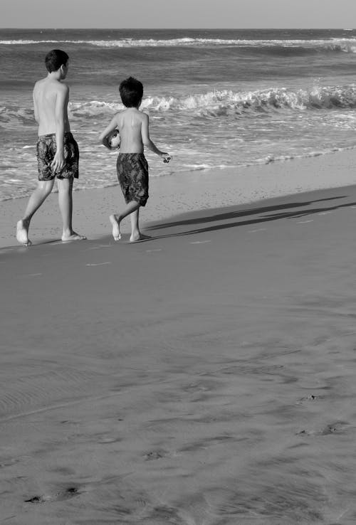 Boys Walking on Beach in Black and White