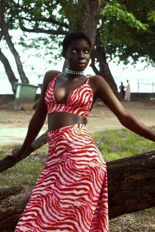 A woman in a red zebra print dress posing for the camera