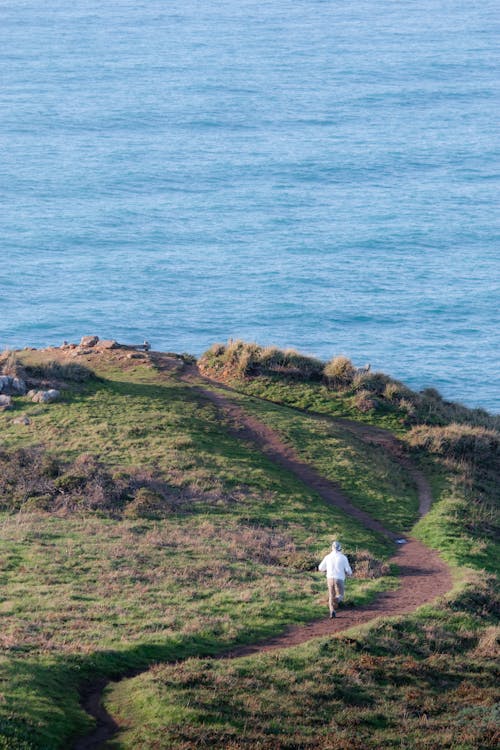 Man Running on Footpath on Sea Coast