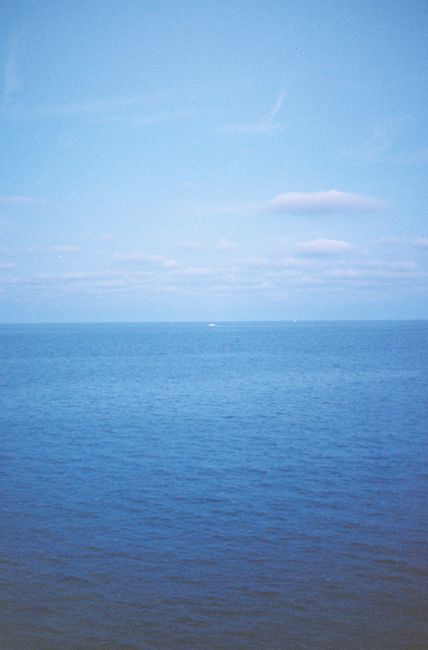 Serene ocean view under a blue sky, capturing nature's calming essence.