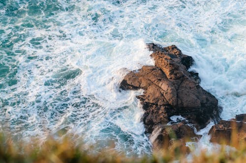 A rocky shoreline with waves crashing into it