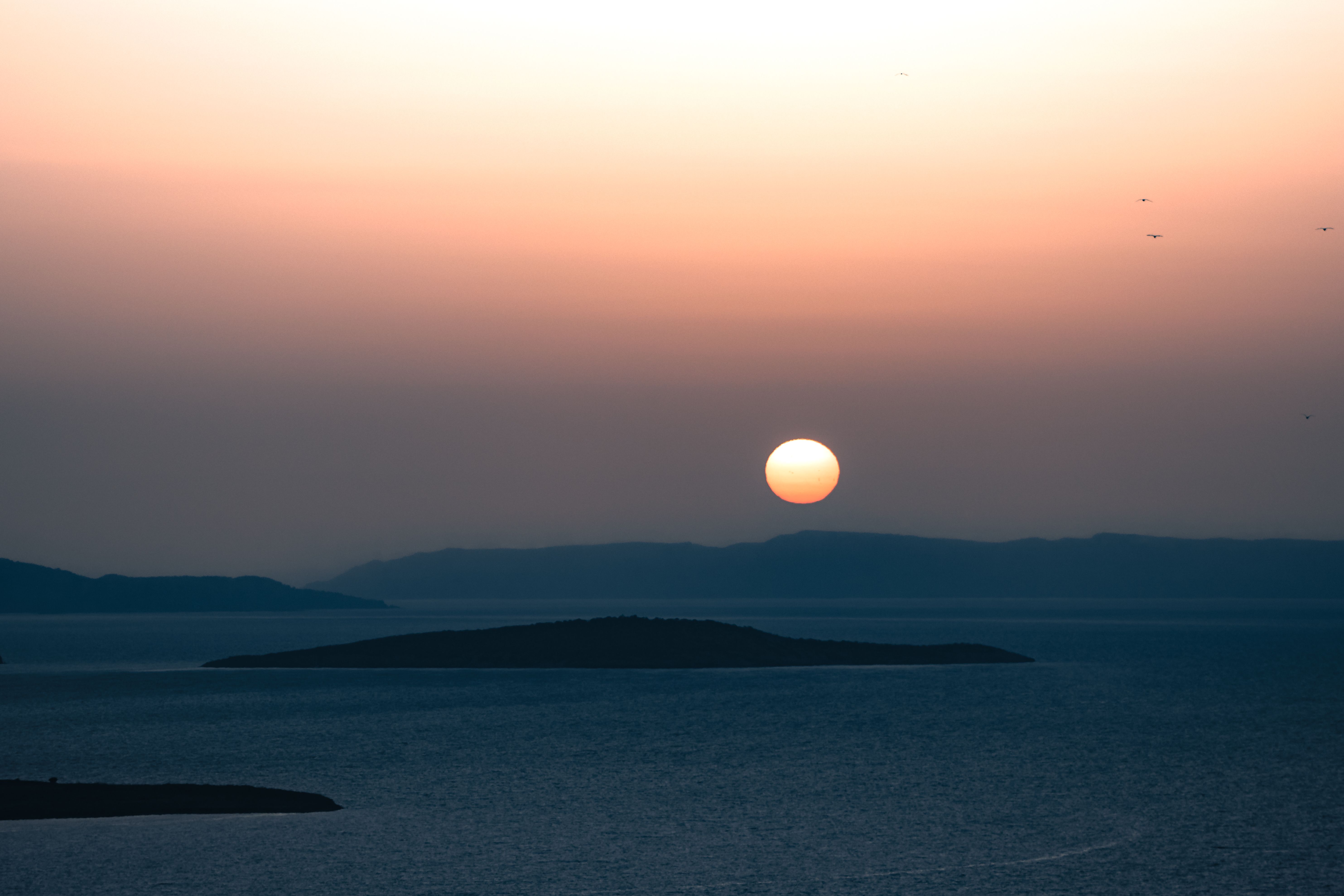 Peaceful sunset view over Ayvalık's islands and sea, capturing nature's beauty.