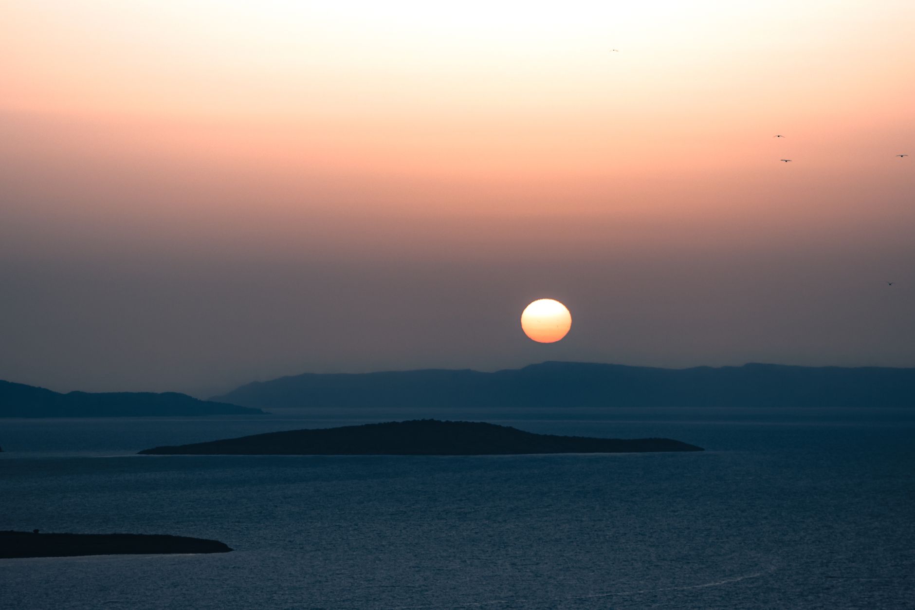 Peaceful sunset view over Ayvalık's islands and sea, capturing nature's beauty.