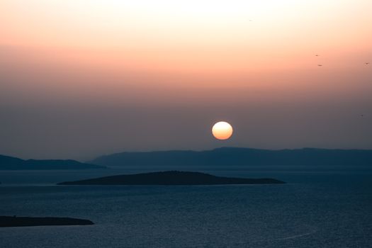 Peaceful sunset view over Ayvalık's islands and sea, capturing nature's beauty.