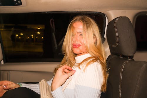 Blonde Woman Sitting in a Car