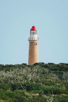 Scenic view of Cape du Couedic Lighthouse amidst rugged vegetation, Flinders Ranges.