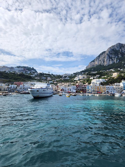 Cruise Ship on Sea Shore in Town in Italy