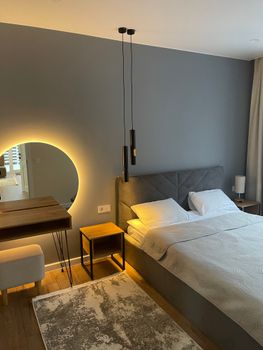 Contemporary hotel bedroom with elegant decor and soft lighting for a cozy ambiance.