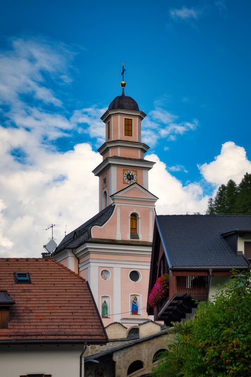 Free Beautiful church tower in Sexten, Trentino, against a vibrant blue sky. Stock Photo
