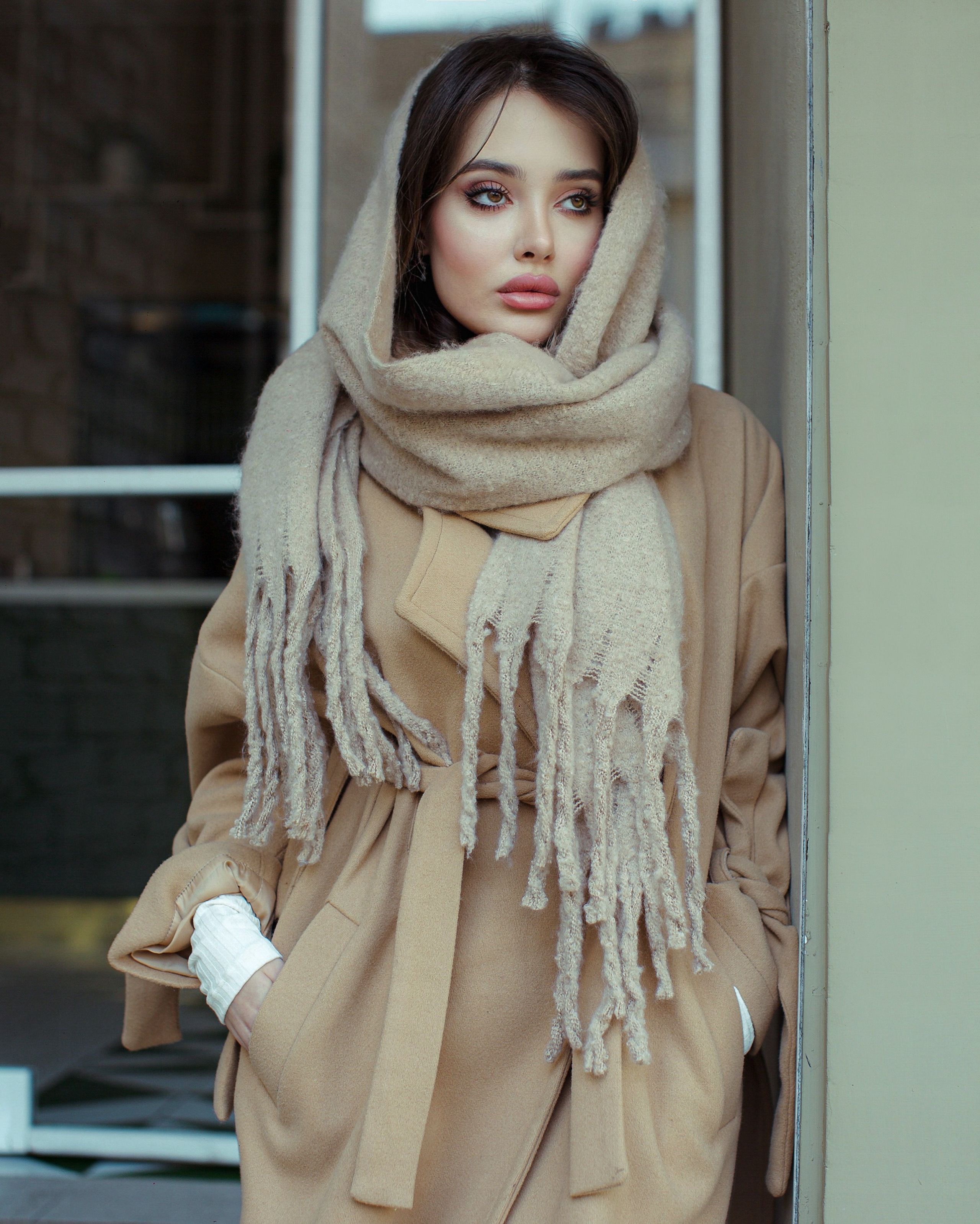 Woman in camel coat with cream monochrome outfit