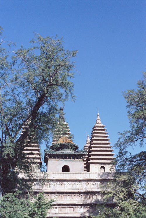 A temple with two towers and a green roof