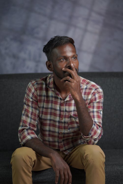 Man in Shirt Sitting and Thinking