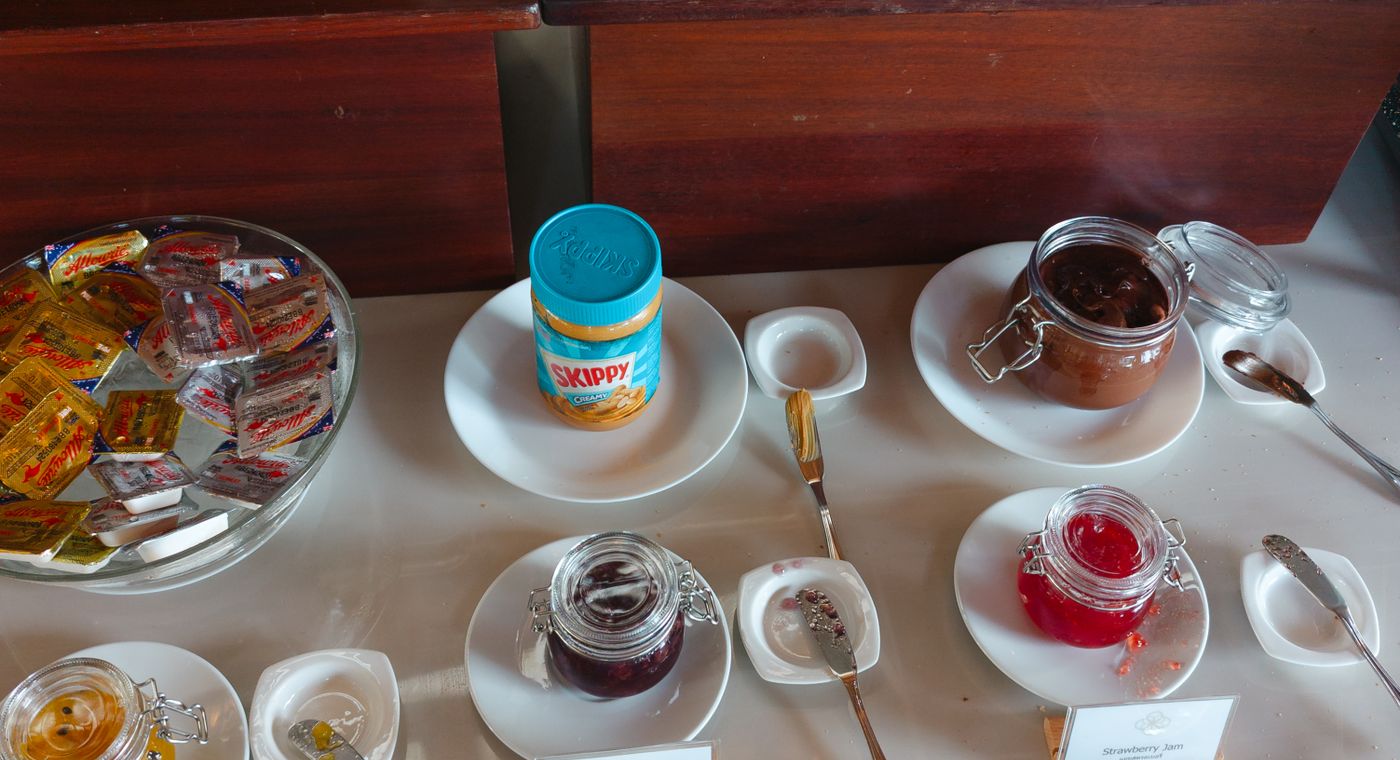 A spread of breakfast foods including eggs, fruit, and bread on a table