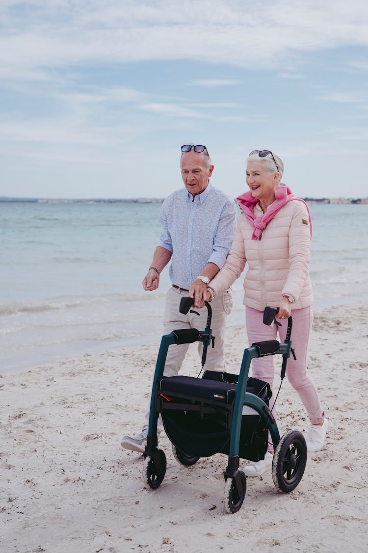 Elderly Couple Walking At The Beach