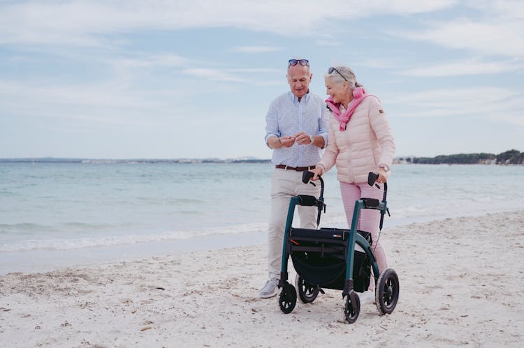 Elderly Couple Walking At The Beach