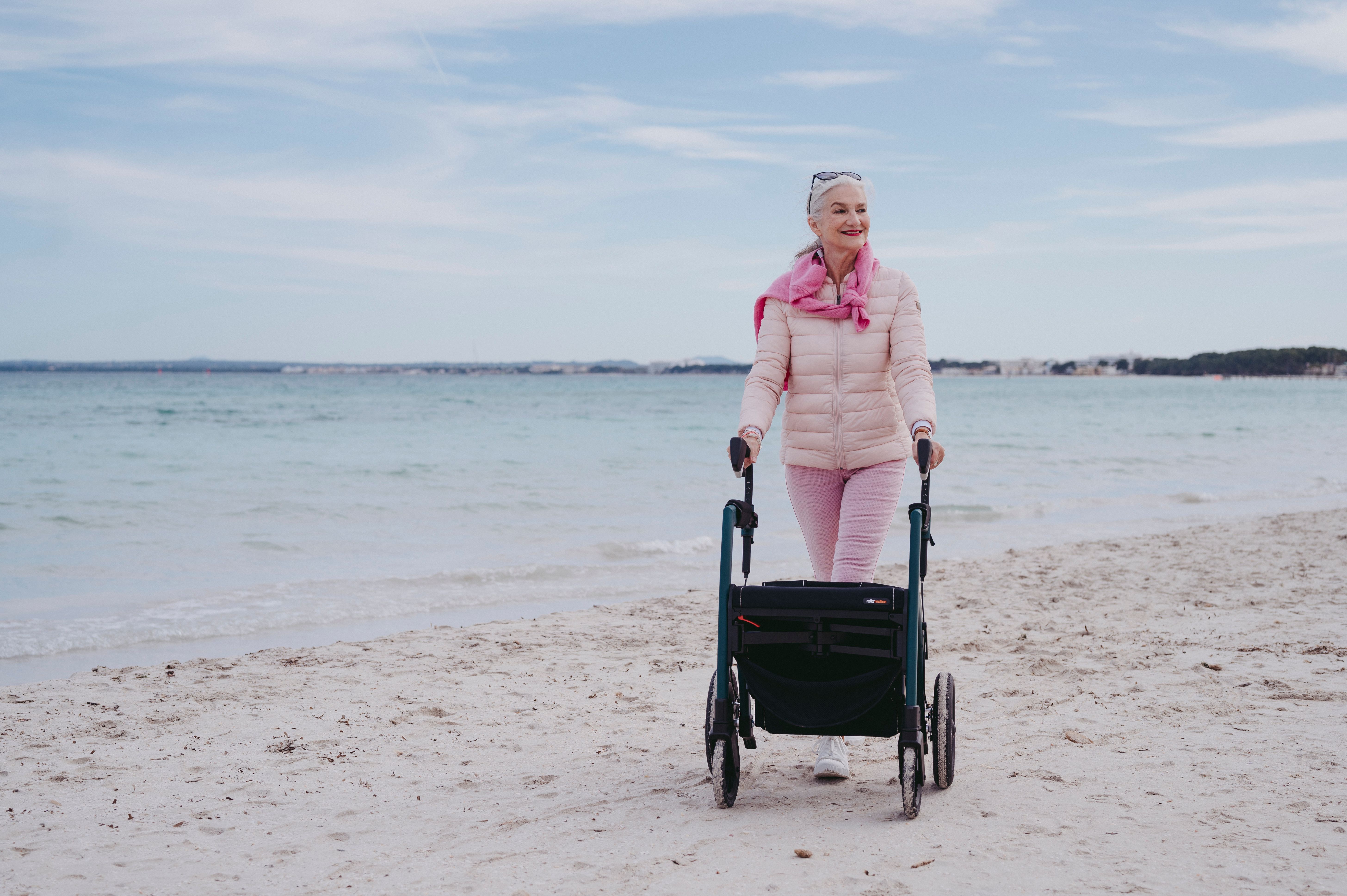Smiling Woman with Walker on Beach · Free Stock Photo