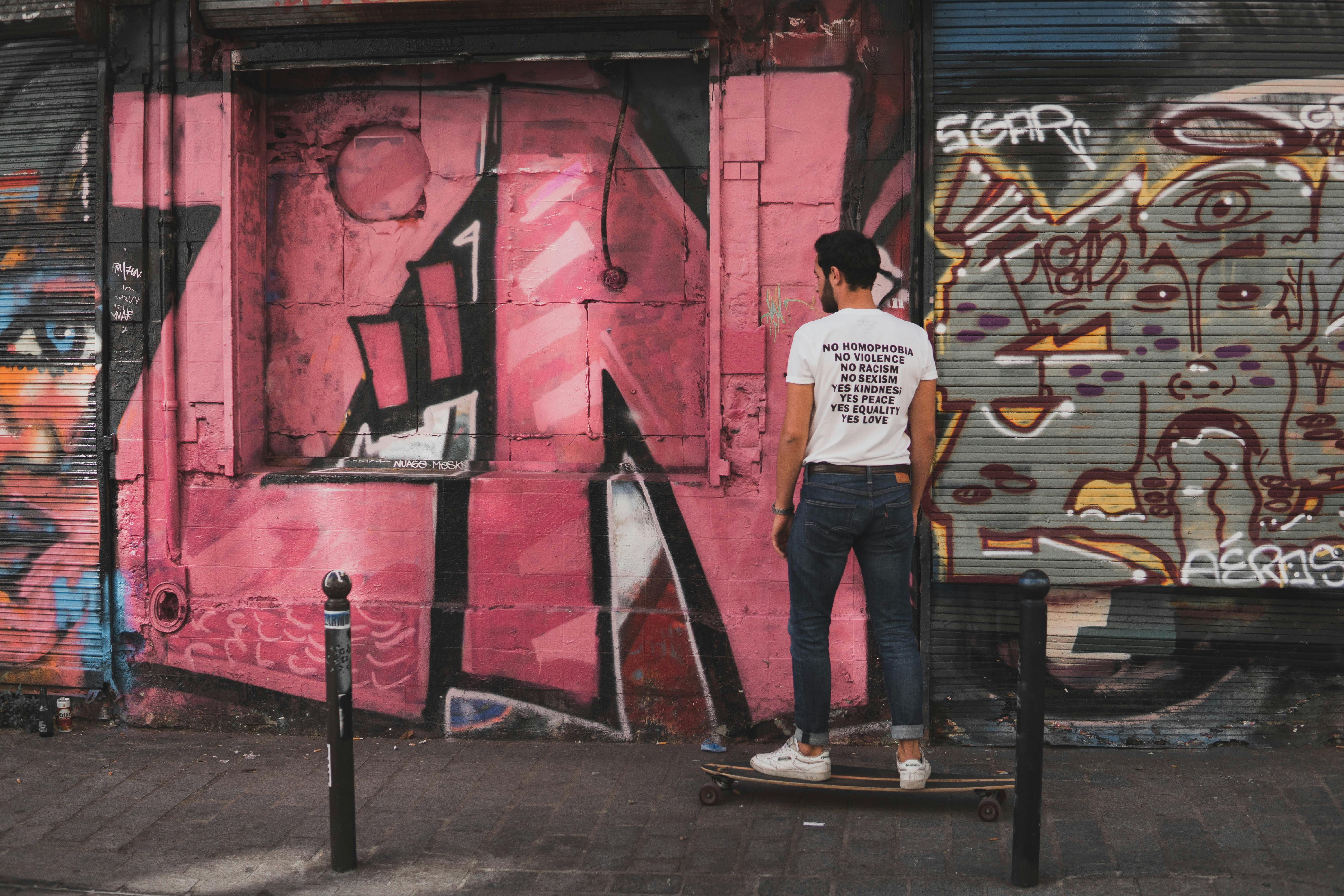 Man Wearing Black and Red Supreme Shirt Standing by the Constructed  Building · Free Stock Photo