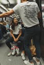 Woman Wearing White Crew-neck Shirt and Black Jeans Sitting on Train Seat