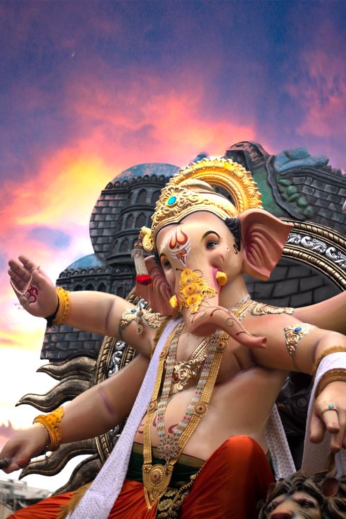 Free Vibrant Ganesha statue with intricate details against a sunset sky, symbolizing Hindu culture and spirituality. Stock Photo