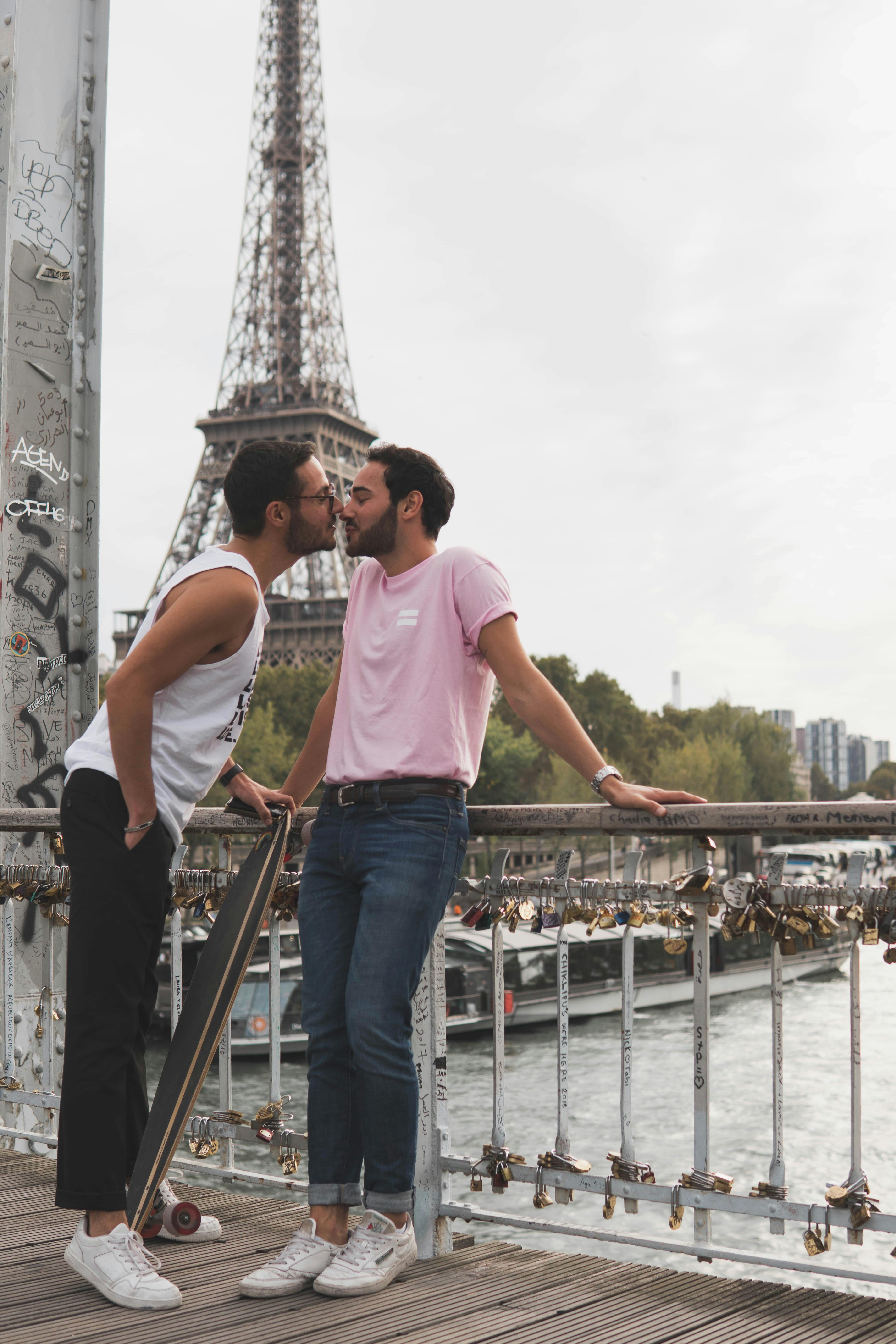 Two Men Standing Beside Rail