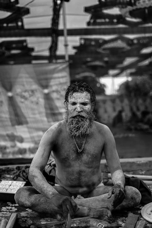 Man Sitting with Painted Face in Black and White