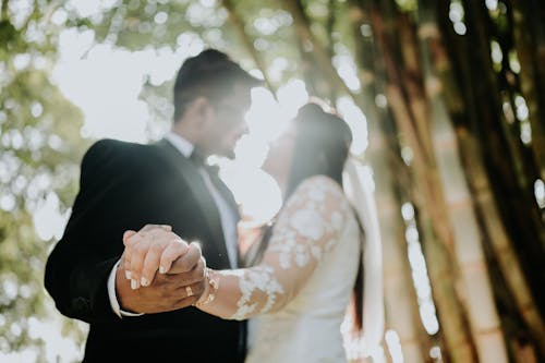 Newlyweds Holding Hands at Sunset