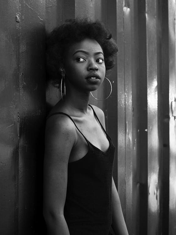 Woman Standing on Front of Metal Wall