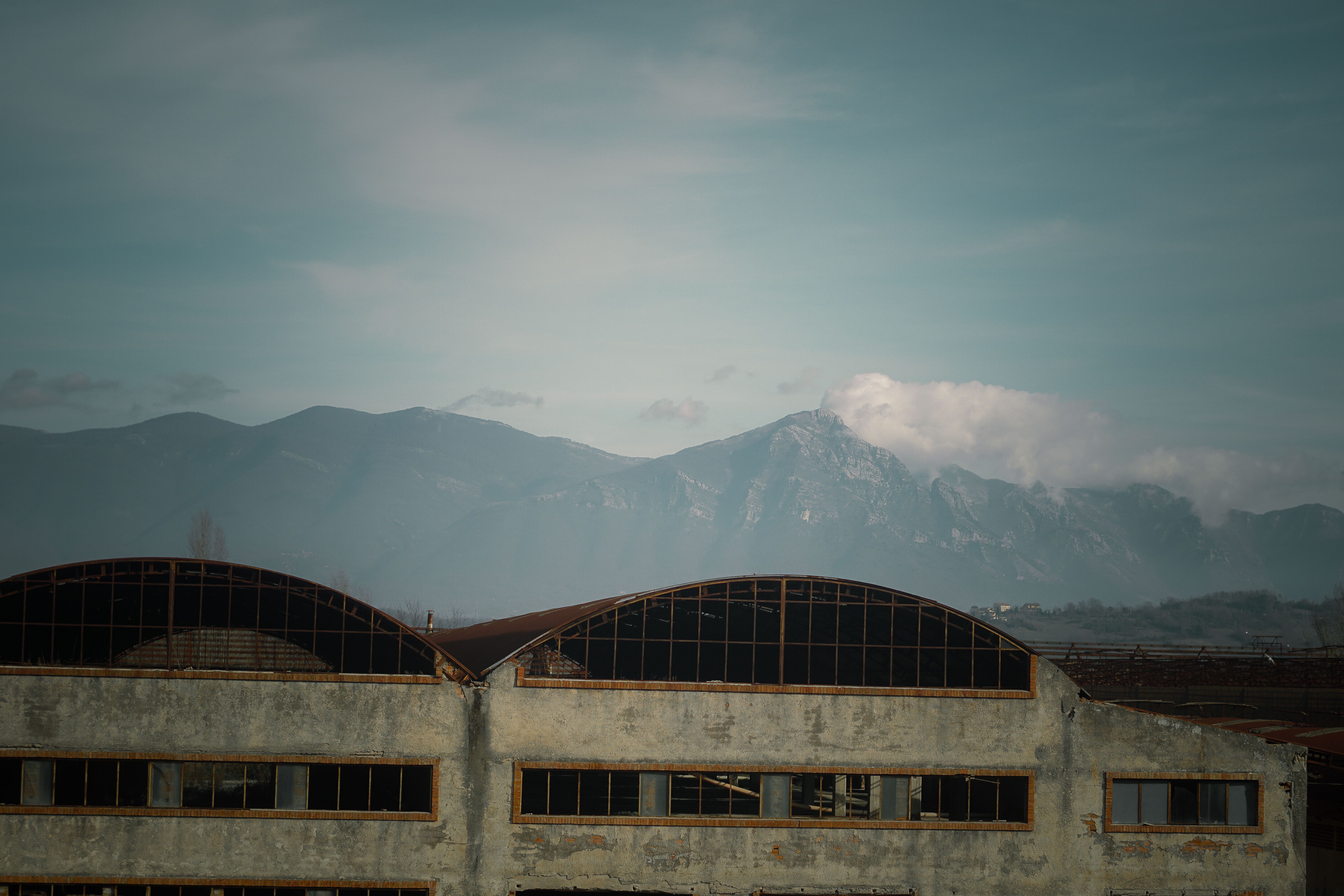 Warehouse against Alpine Mountains