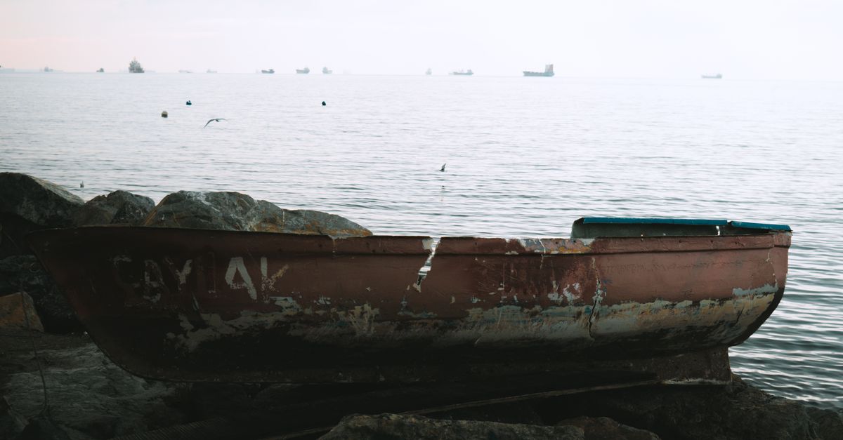 Boat on the Rocks by the Lake · Free Stock Photo