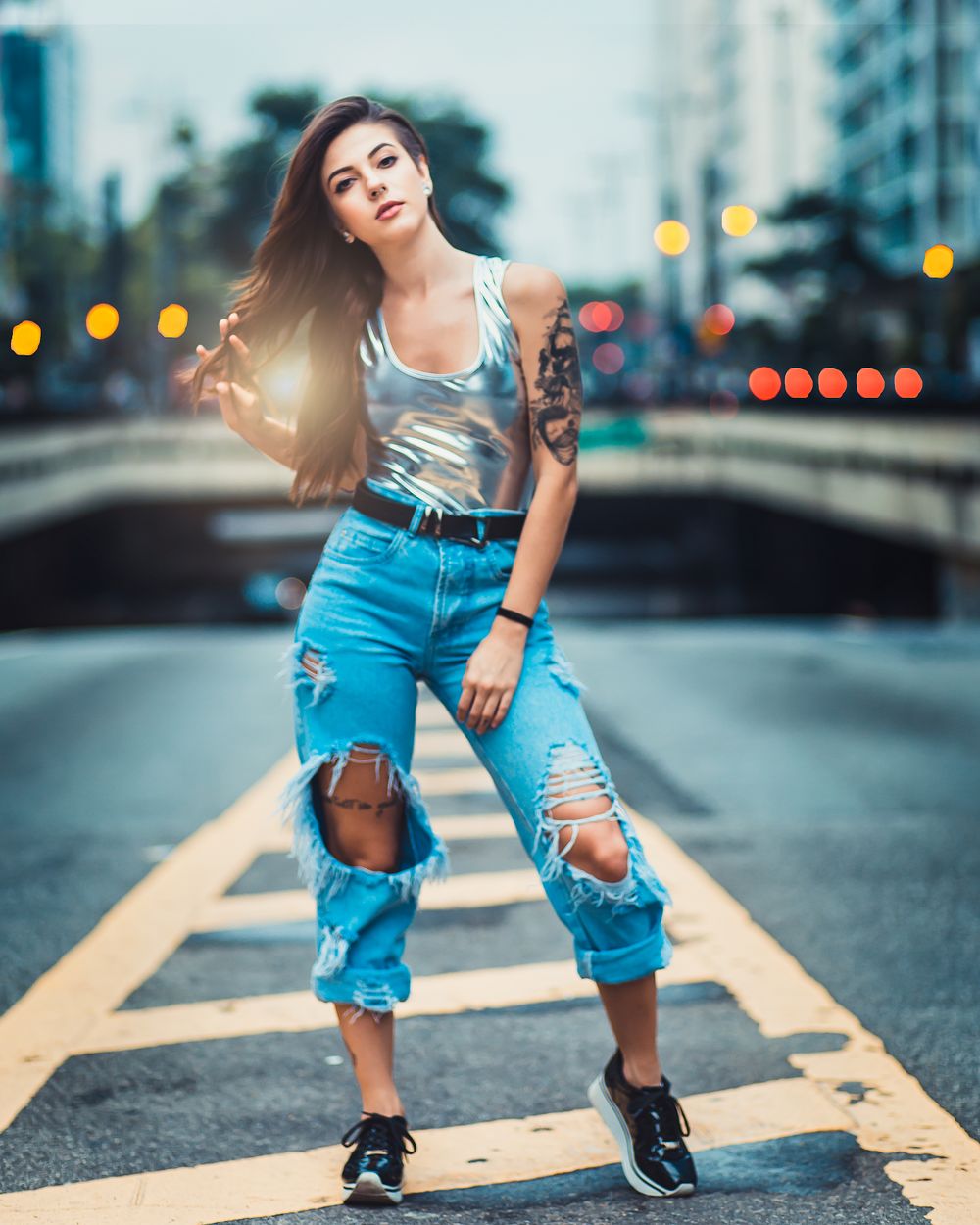 Woman in sequin top and distressed jeans