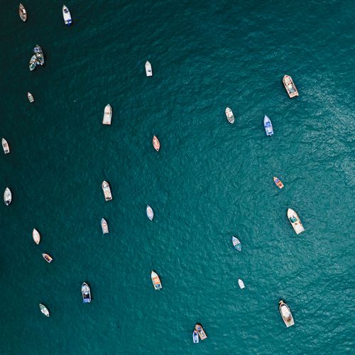 Free A stunning aerial view of boats floating in the ocean near Huacho, Peru. Stock Photo