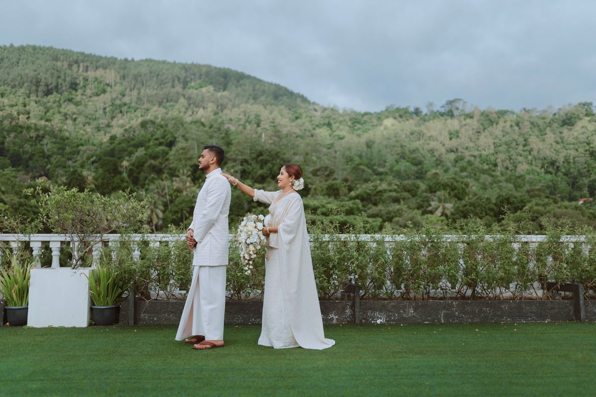 First look between bride and groom in Kandy, Sri Lanka amidst lush greenery