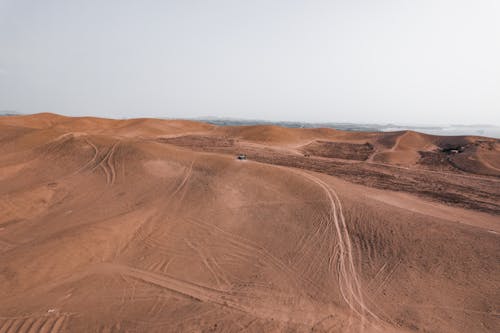 A Car Driving in a Desert 