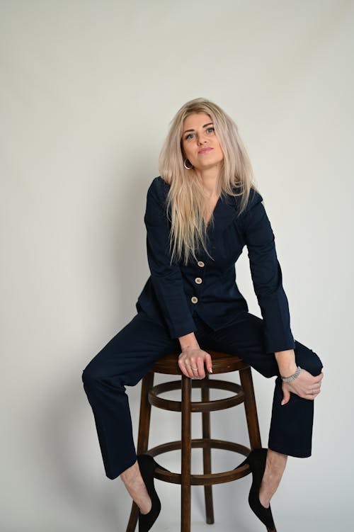 Blonde Woman in Suit Sitting on Chair