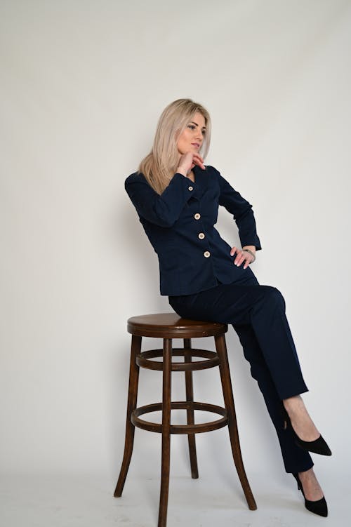 Blonde Woman in Shirt Sitting on Chair