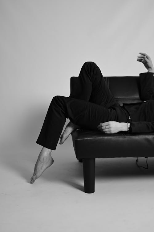 Barefoot Model Lying Down on Couch in Black and White