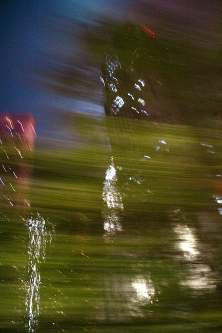 Abstract blurred cityscape photo capturing Kuala Lumpur's vibrant night lights.