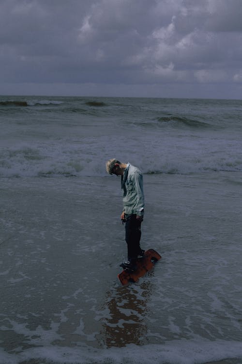 Man standing on the beach with skate board 🛹 (Oceania background) | lostintespace • by Amaan