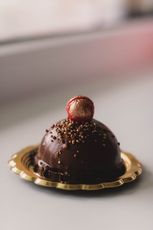 Free Close-Up Photo Of Chocolate Cake On A Gold-Colored Saucer Stock Photo