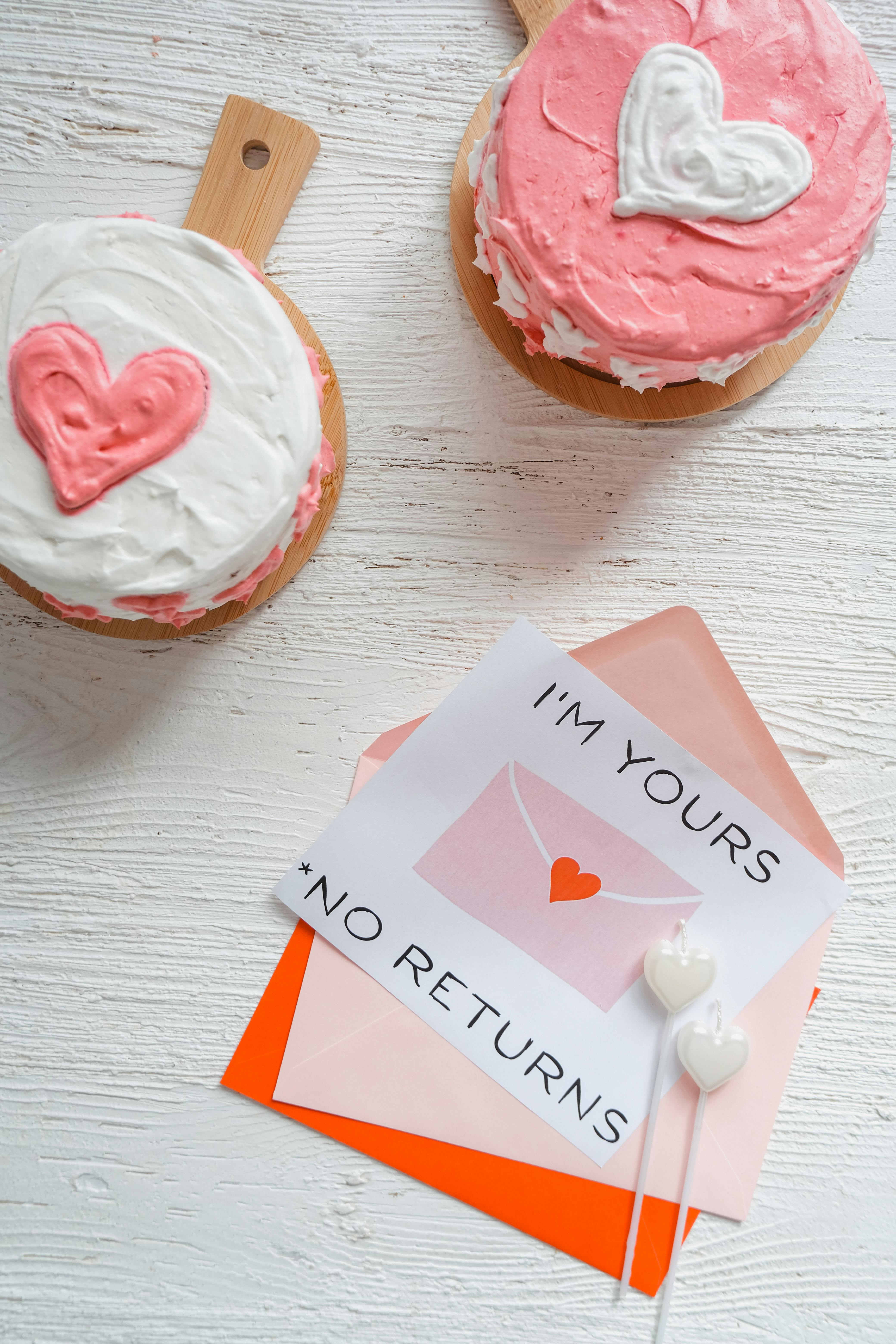 Heart-shaped cakes and a love note on white background, perfect for romantic occasions.